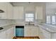 Spacious kitchen featuring white cabinets, granite counters, and a stainless steel dishwasher at 1924 Wilkenson Xing, Marietta, GA 30066