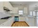 Bright kitchen with white cabinets, granite counters, and stainless steel appliances at 1924 Wilkenson Xing, Marietta, GA 30066