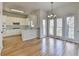 Open kitchen and dining area featuring hardwood floors and lots of natural light at 1924 Wilkenson Xing, Marietta, GA 30066