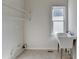 Functional laundry room with a utility sink, shelving, and a window at 1924 Wilkenson Xing, Marietta, GA 30066