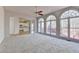 Open living room with large arched windows, neutral carpet, and view of the kitchen at 1924 Wilkenson Xing, Marietta, GA 30066