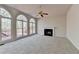 Spacious living room featuring large arched windows, a fireplace, and neutral carpet at 1924 Wilkenson Xing, Marietta, GA 30066