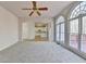 Bright living room with large windows overlooking a deck and view of the white kitchen at 1924 Wilkenson Xing, Marietta, GA 30066