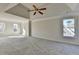 Spacious primary bedroom featuring a trey ceiling, neutral carpet and large windows at 1924 Wilkenson Xing, Marietta, GA 30066