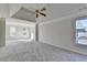 Large primary bedroom featuring a trey ceiling, neutral carpet and large windows at 1924 Wilkenson Xing, Marietta, GA 30066