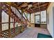 Screened in porch with stairs, brick flooring, a ceiling fan and wooden supports at 1924 Wilkenson Xing, Marietta, GA 30066