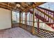 Screened in porch with stairs, brick flooring, a ceiling fan and wooden supports at 1924 Wilkenson Xing, Marietta, GA 30066
