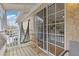 Balcony featuring wooden floors, an outdoor hammock, and a large glass sliding door at 3155 Seven Pines Ct # 303, Atlanta, GA 30339