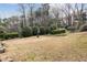 A grassy area with well-manicured bushes, shrubs, and landscaping, set against an apartment building at 3155 Seven Pines Ct # 303, Atlanta, GA 30339