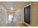 Hallway featuring a black door, a welcome mat, and an archway leading to stairs at 3155 Seven Pines Ct # 303, Atlanta, GA 30339