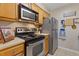 A charming kitchen with stainless steel appliances and ample wooden cabinet space at 3155 Seven Pines Ct # 303, Atlanta, GA 30339