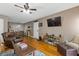 Open living room featuring hardwood floors, TV, a ceiling fan and dining area at 3155 Seven Pines Ct # 303, Atlanta, GA 30339