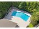 An aerial close up of the backyard pool surrounded by a stone patio and mature trees at 3155 Seven Pines Ct # 303, Atlanta, GA 30339