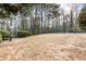 View of a tennis court surrounded by a chain-link fence and trees at 3155 Seven Pines Ct # 303, Atlanta, GA 30339