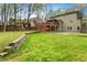 A lush green backyard features a retaining wall, swing set, and access to the home's elevated deck at 4062 Silver Fir Ct, Marietta, GA 30066