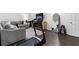 The finished basement includes wood floors, a gray sofa, a treadmill, and accent furniture at 4062 Silver Fir Ct, Marietta, GA 30066