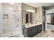 This bathroom features a glass shower with marble tile and a dual sink vanity with neutral gray cabinetry at 4062 Silver Fir Ct, Marietta, GA 30066