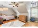 This bedroom features hardwood floors, a ceiling fan, and natural light at 4062 Silver Fir Ct, Marietta, GA 30066
