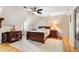 A bedroom with hardwood floors, ceiling fan, furnishings, and a bright and airy space at 4062 Silver Fir Ct, Marietta, GA 30066