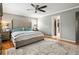 Bedroom featuring a large bed, neutral décor, hardwood floors and a ceiling fan at 4062 Silver Fir Ct, Marietta, GA 30066