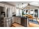 Kitchen and dining area with stainless steel appliances, island, and natural light at 4062 Silver Fir Ct, Marietta, GA 30066