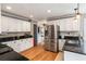 Kitchen featuring white cabinets, granite countertops, stainless steel appliances, and hardwood floors at 4062 Silver Fir Ct, Marietta, GA 30066