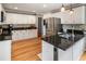 Kitchen featuring white cabinets, granite countertops, stainless steel appliances, and hardwood floors at 4062 Silver Fir Ct, Marietta, GA 30066