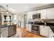 Kitchen featuring stainless steel appliances, granite countertops, and white cabinets at 4062 Silver Fir Ct, Marietta, GA 30066