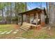 Cozy outbuilding with covered porch providing a tranquil retreat within the tree lined property at 4062 Silver Fir Ct, Marietta, GA 30066