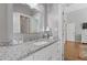 Stylish bathroom featuring a granite countertop, white cabinets, and a well-lit mirror at 459 James P Brawley Nw Dr, Atlanta, GA 30318