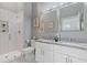 Bright bathroom featuring granite countertop, double sinks, and modern glass shower at 459 James P Brawley Nw Dr, Atlanta, GA 30318