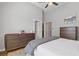 Neutral bedroom with ceiling fan, walk in closet, and view of modern dresser and decor at 459 James P Brawley Nw Dr, Atlanta, GA 30318