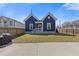 Beautiful blue home with a well-maintained front lawn and a freshly sealed driveway at 459 James P Brawley Nw Dr, Atlanta, GA 30318