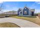 Beautiful blue home with a well-maintained front lawn and a freshly sealed driveway at 459 James P Brawley Nw Dr, Atlanta, GA 30318