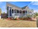 Charming two-story home featuring a welcoming front porch with white railings and a well-maintained lawn at 459 James P Brawley Nw Dr, Atlanta, GA 30318