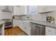 Bright kitchen features white cabinets, granite counters, stainless steel appliances, and farmhouse sink at 459 James P Brawley Nw Dr, Atlanta, GA 30318