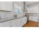 Bright kitchen featuring white cabinets, stainless steel appliances, granite countertops, and subway tile backsplash at 459 James P Brawley Nw Dr, Atlanta, GA 30318