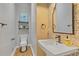 Charming powder room with modern fixtures, decorative mirror, and patterned accent wall at 459 James P Brawley Nw Dr, Atlanta, GA 30318
