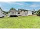 Large backyard with a deck and generous lawn area, ideal for Gathering fun and outdoor gatherings at 5880 April Dr, Sugar Hill, GA 30518