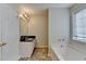Bathroom with tub and vanity with dark countertop at 5880 April Dr, Sugar Hill, GA 30518