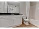 The bathroom features a vanity with black countertops, a toilet, and a shower/tub combo at 5880 April Dr, Sugar Hill, GA 30518