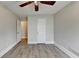 Bright bedroom featuring hardwood floors, modern ceiling fan, and natural light at 5880 April Dr, Sugar Hill, GA 30518