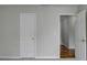 Bright bedroom with a classic six-panel door and hardwood floors beyond the doorway at 5880 April Dr, Sugar Hill, GA 30518