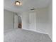 A well-lit bedroom with plush carpeting, and a glimpse of hardwood floors beyond the doorway at 5880 April Dr, Sugar Hill, GA 30518