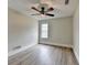 This bedroom features hardwood flooring, ceiling fan, and natural light at 5880 April Dr, Sugar Hill, GA 30518
