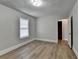 This bedroom features wood-look flooring, a window for natural light and a closet at 5880 April Dr, Sugar Hill, GA 30518