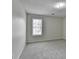 Bright bedroom with neutral carpet and a window at 5880 April Dr, Sugar Hill, GA 30518