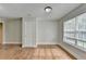 Bright bedroom with hardwood floors, a window, and a closet door at 5880 April Dr, Sugar Hill, GA 30518