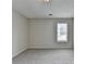 Neutral bedroom with carpet flooring, and a large window with blinds at 5880 April Dr, Sugar Hill, GA 30518