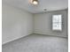 A cozy bedroom bathed in natural light from the window, enhancing the plush carpeting at 5880 April Dr, Sugar Hill, GA 30518